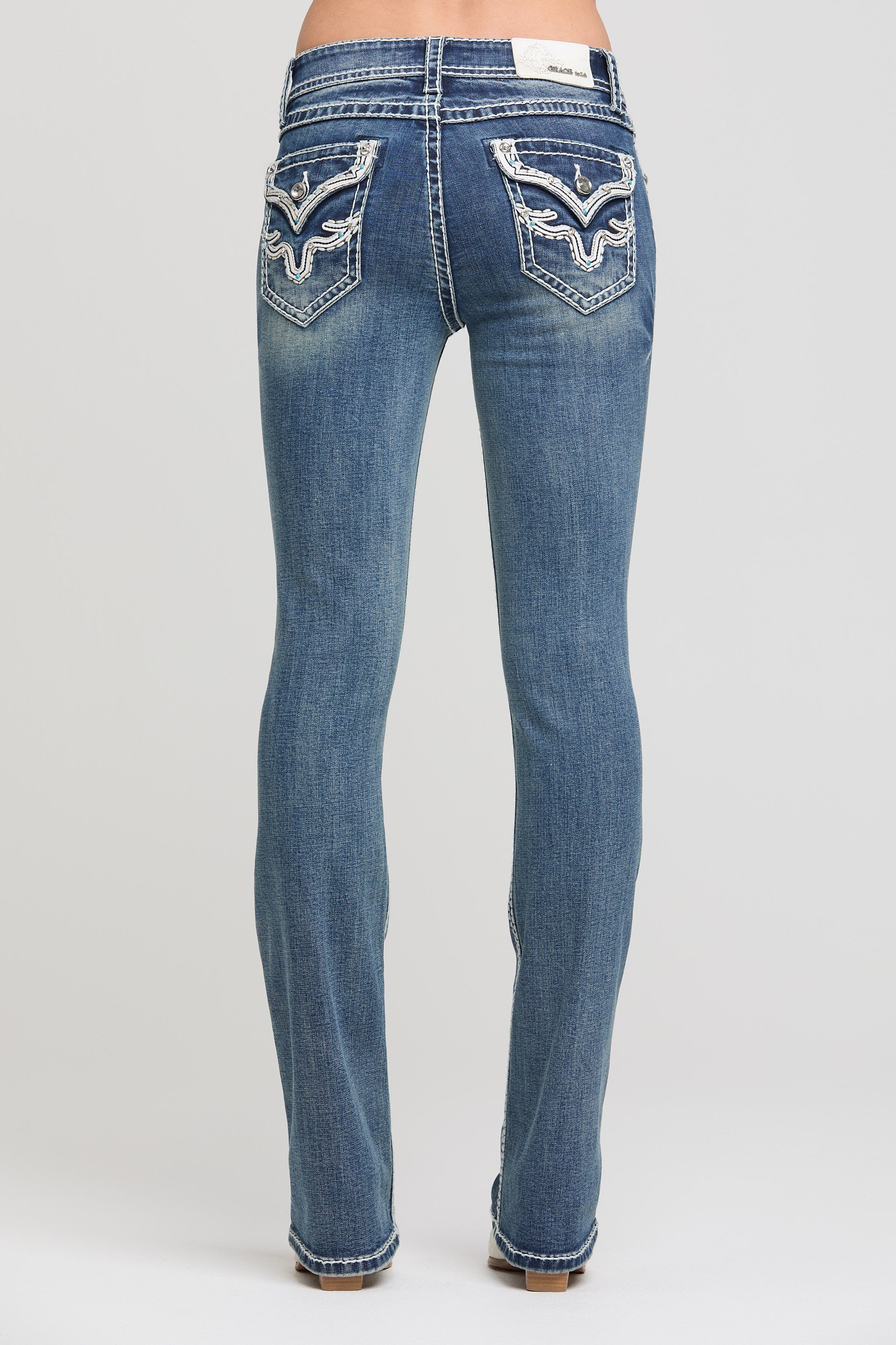 Grace in LA women's medium wash bootcut jeans, full-length back view with a classic bootcut silhouette