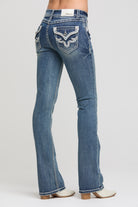 Grace in LA women's medium wash bootcut jeans, side-facing view showing the fitted hip and bootcut leg