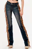 Grace in LA flare jeans for women with long brown western fringe and lace trim along the side seams.