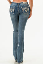 Grace in LA womens bootcut jeans in a medium wash featuring symmetric silver diamond embroidery on the back pockets.