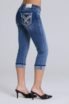 Grace in LA women's capri jeans close-up of geometric embroidery and hand-set rhinestone detailing on medium wash denim