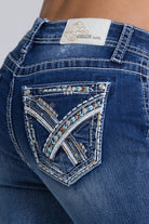 Grace in LA women's medium wash mid-rise capri jeans in a slim easy fit silhouette with geometric embroidery down the leg