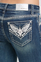 Grace in LA embroidered jeans women featuring silver wing-inspired back pocket designs and a branded metallic silver waist patch on medium denim.