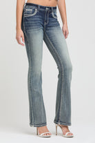 Grace in LA women's acid wash jeans in a bootcut fit featuring thick white contrast stitching and silver hardware accents on the front pockets.