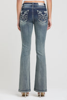 Grace in LA women's acid wash jeans in a bootcut fit featuring symmetrical metallic silver wing embroidery on both back pockets.