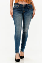 Grace in LA western jeans for women featuring a dark indigo wash with natural whiskering and a slim fit silhouette.