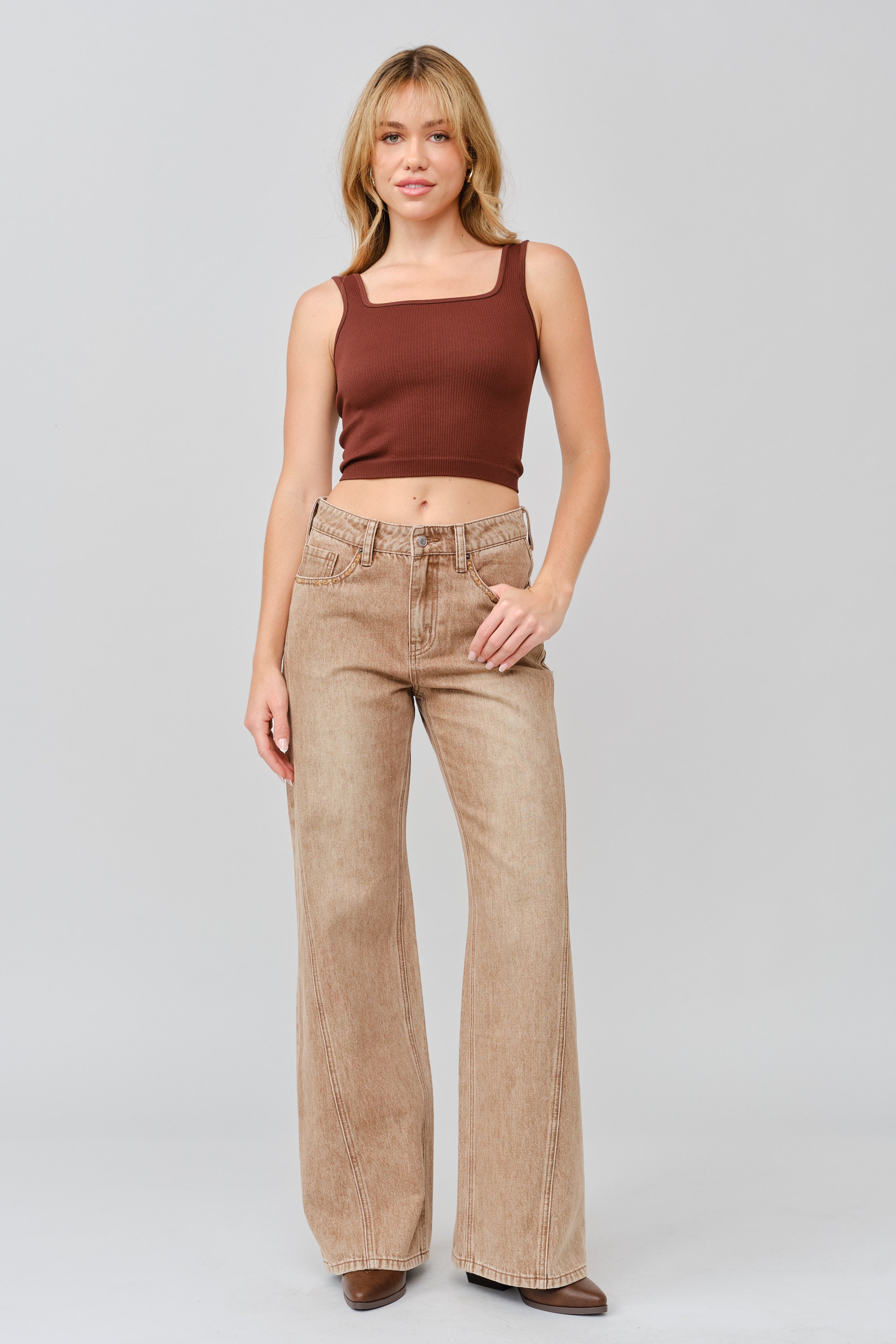 Grace in LA women's light wash flare jeans styled for a casual western-inspired look