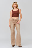 Grace in LA women's light wash flare jeans styled for a casual western-inspired look