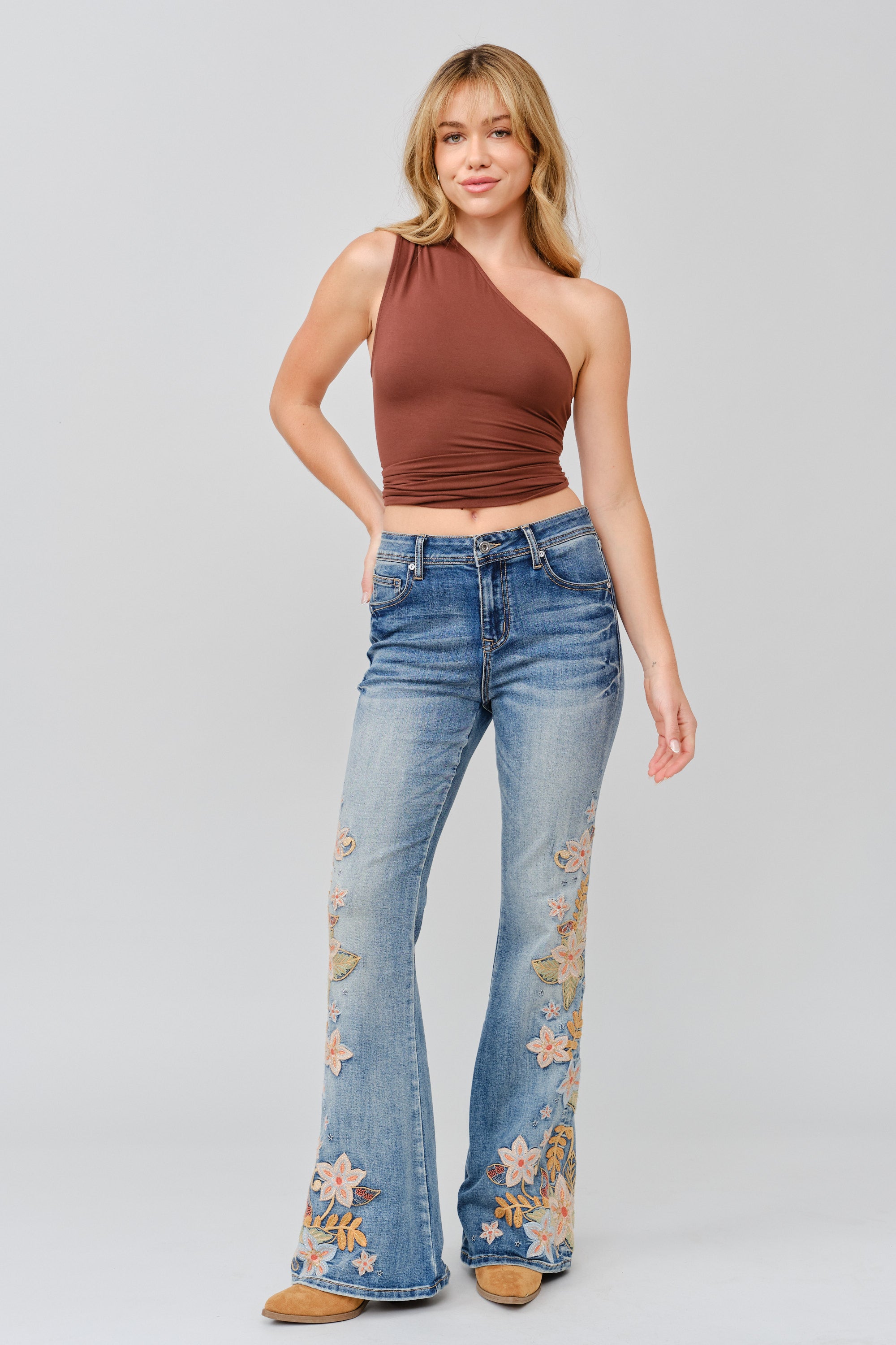 Grace in LA flare jeans back pocket detail featuring silver floral embroidery on medium wash denim