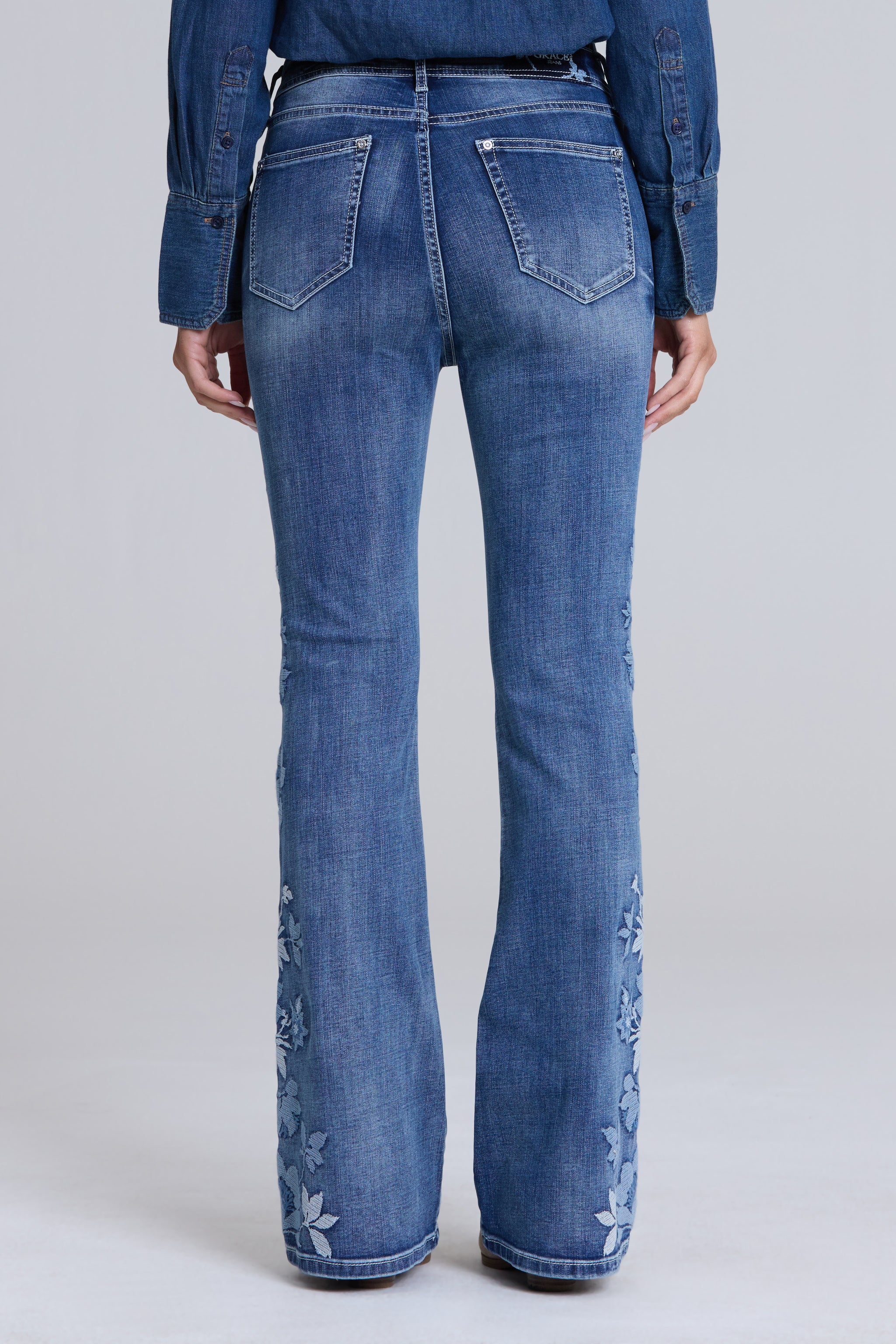 Grace in LA women's medium wash floral embroidered flare jeans styled for a boho-inspired look