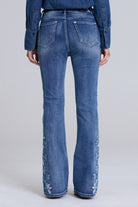 Grace in LA women's medium wash floral embroidered flare jeans styled for a boho-inspired look