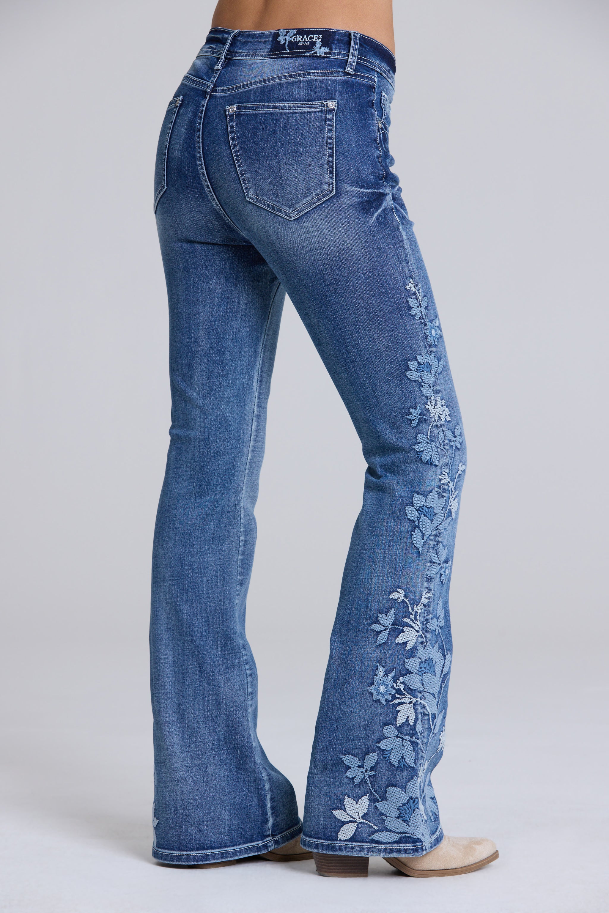 Grace in LA women's flare jeans close-up of floral embroidery detailing on medium wash denim
