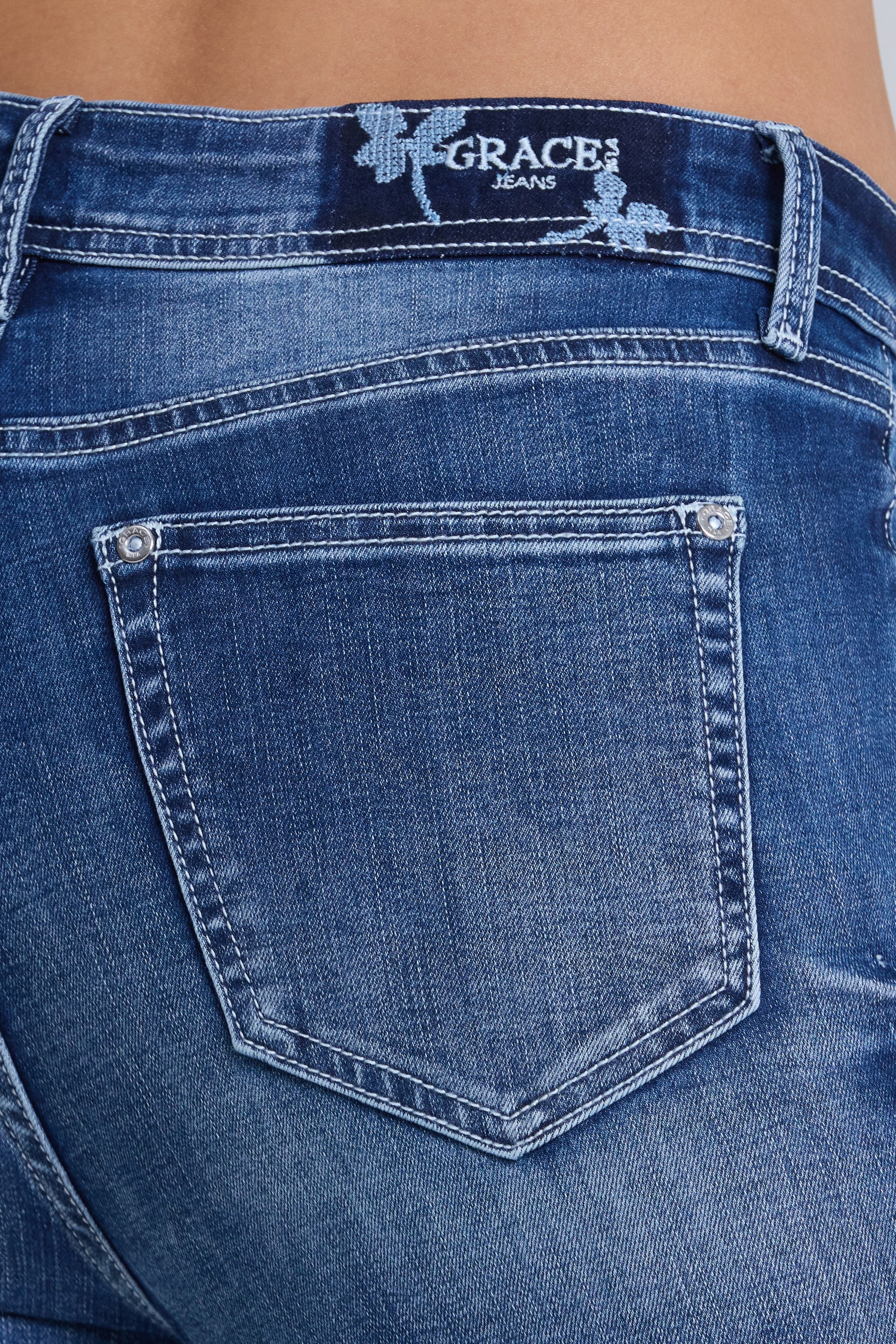 Grace in LA women's medium wash flare jeans in a contemporary boho silhouette with floral embroidery down the leg