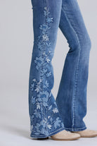 Grace in LA women's medium wash floral embroidered flare jeans, front-facing view with boho-inspired embroidery detailing