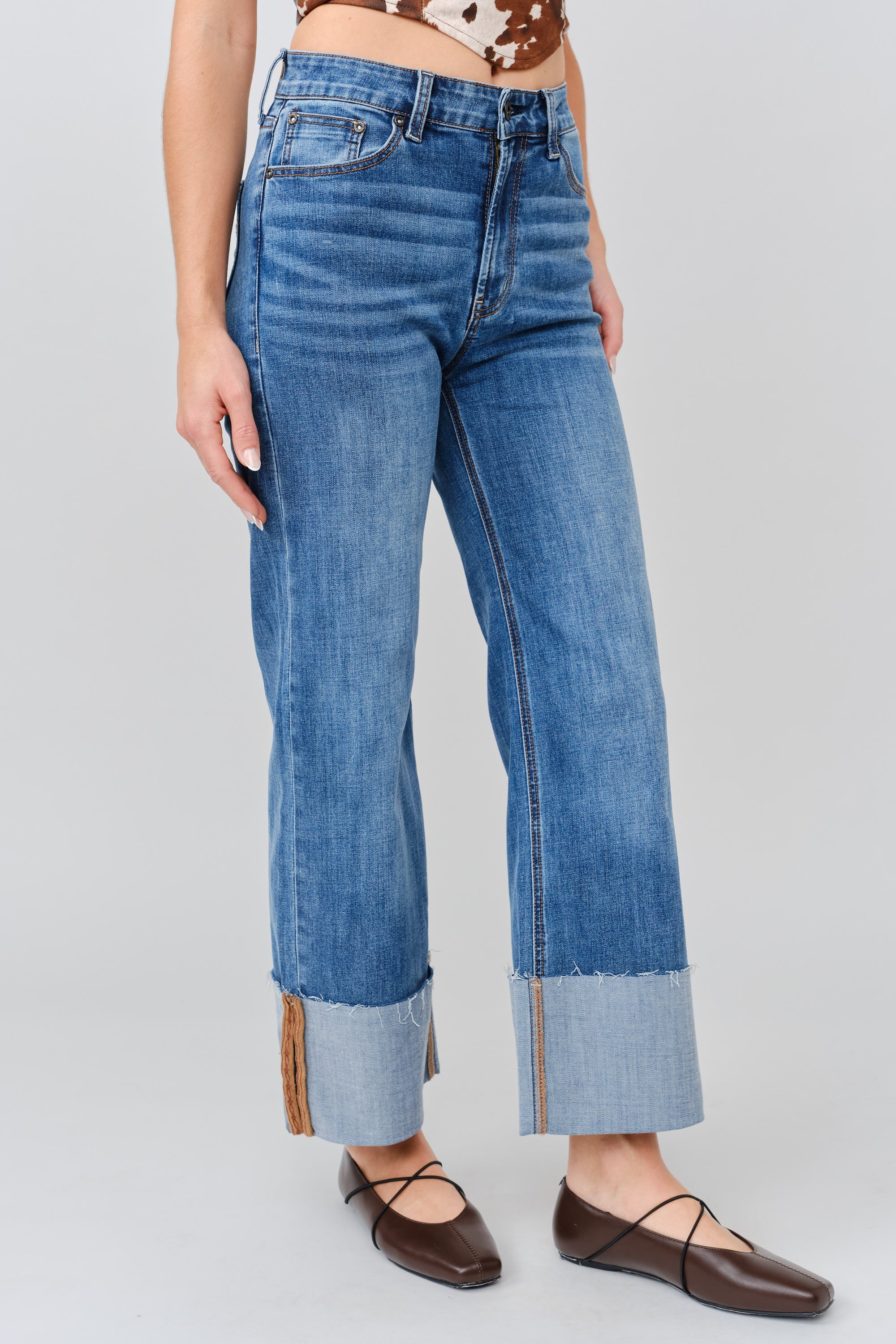 Grace in LA women's medium wash flare jeans, full-length view styled for a casual western-inspired look