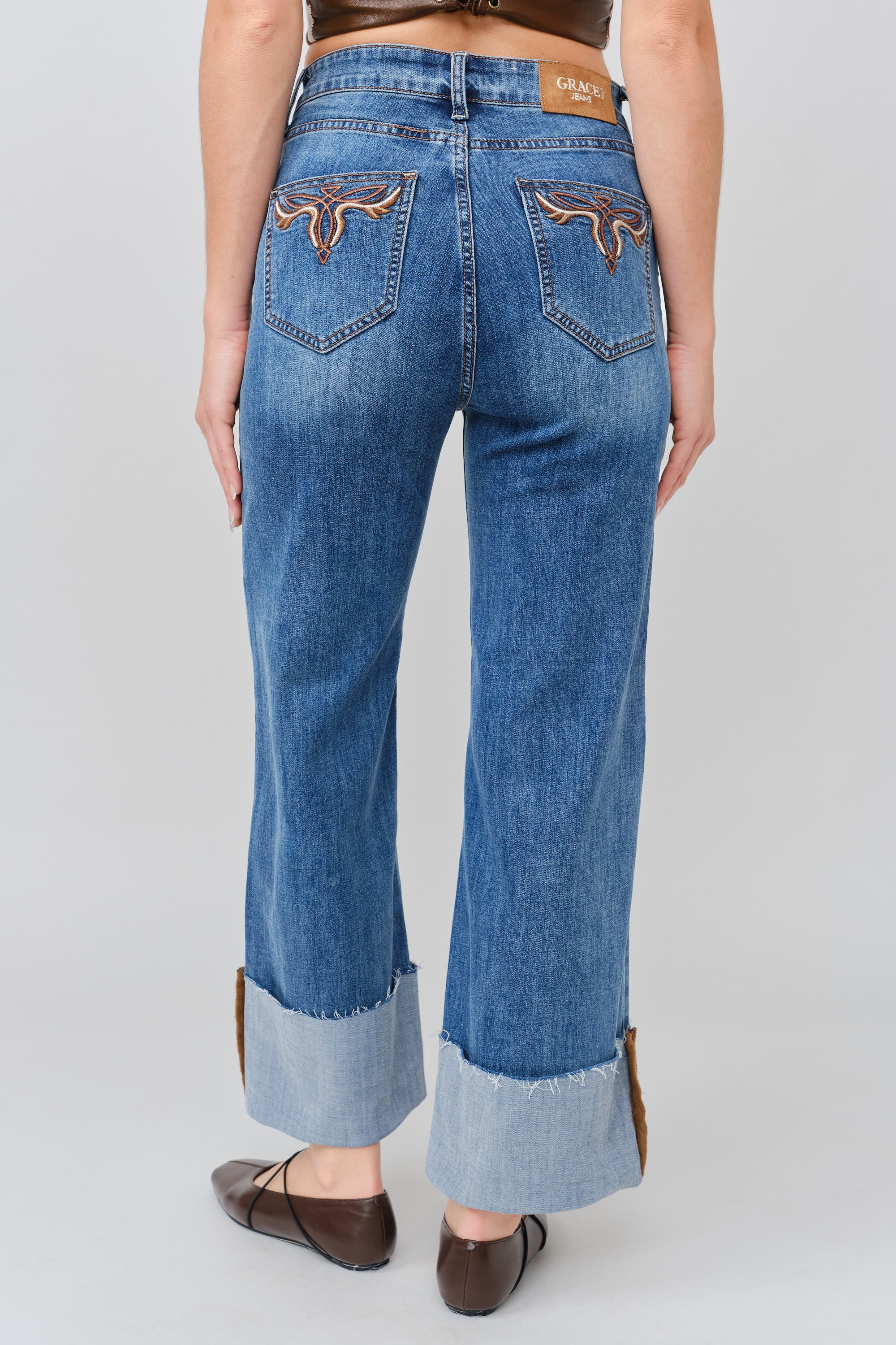 Grace in LA women's medium wash flare jeans, full-length front view showing the fitted silhouette and flared leg