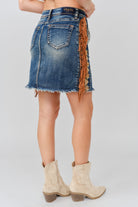 Grace in LA denim skirt close-up of tassel fringe embroidery detailing