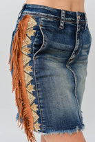 Grace in LA women's medium wash tassel fringe embroidered denim skirt styled for a western-inspired look