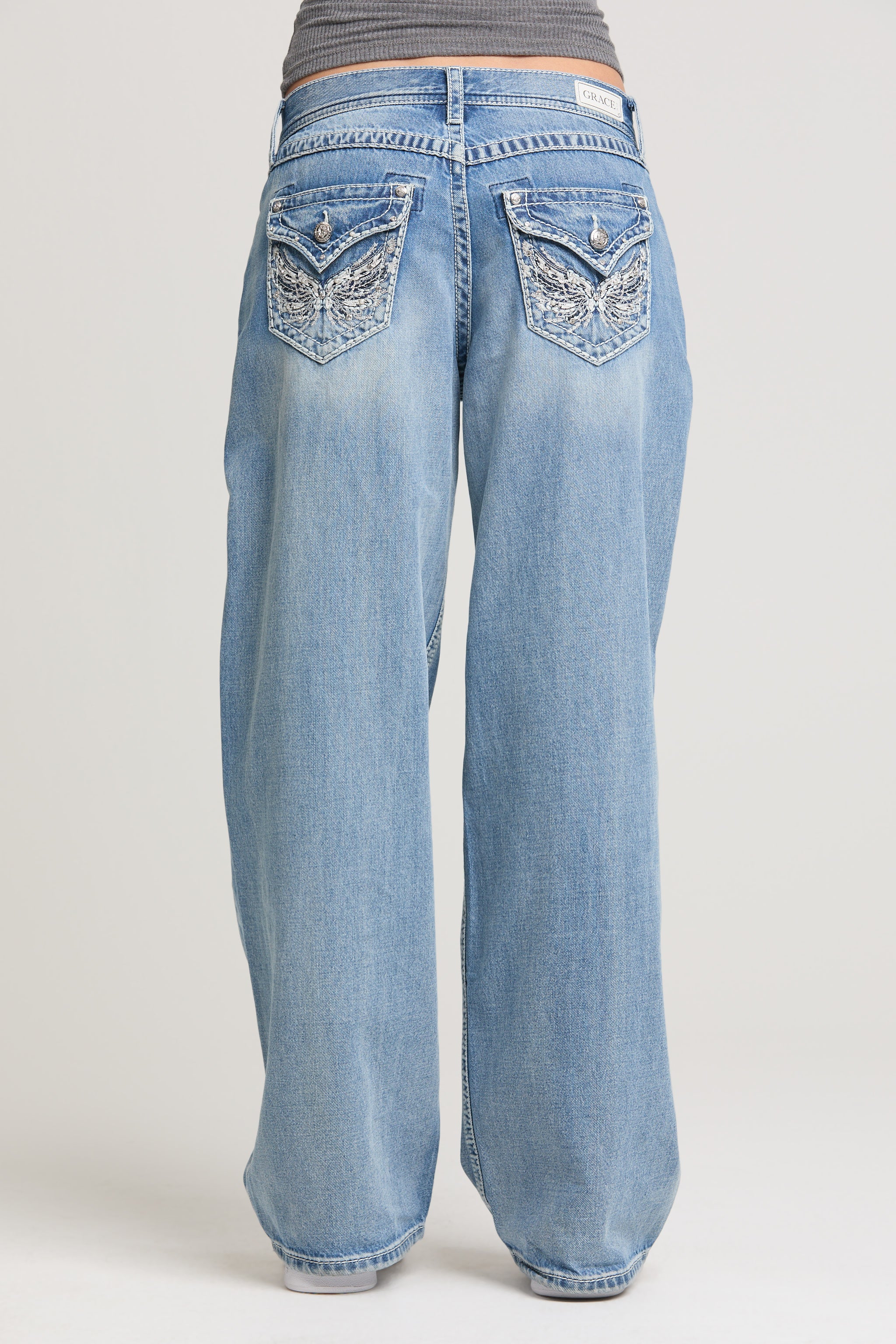 Grace in LA women’s light wash wide leg jeans with decorative back flap pockets