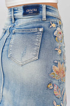Grace in LA denim skirt back pocket detail featuring floral colored embroidery