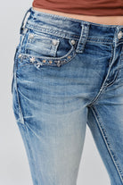 Grace in LA capri jeans close-up of floral yoke with faux flap design on medium wash denim