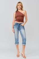 Grace in LA women's medium wash mid-rise capri jeans, front-facing view with floral yoke with faux flap design