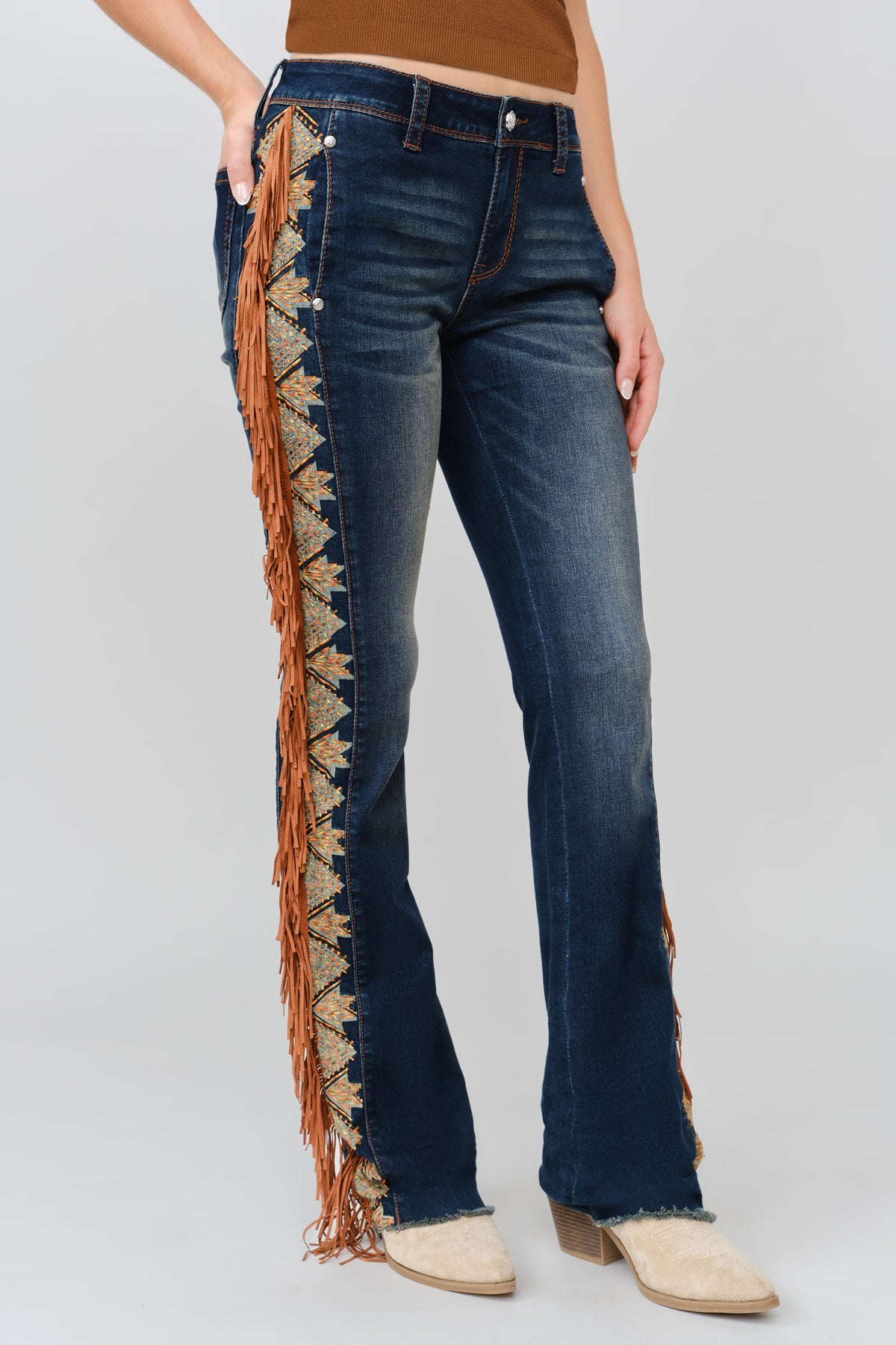 Grace in LA dark wash bootcut jeans close-up of Aztec-inspired embroidery and cognac suede fringe