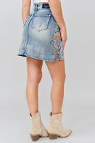 Grace in LA women's light wash floral colored embroidery denim skirt styled for a western-inspired look