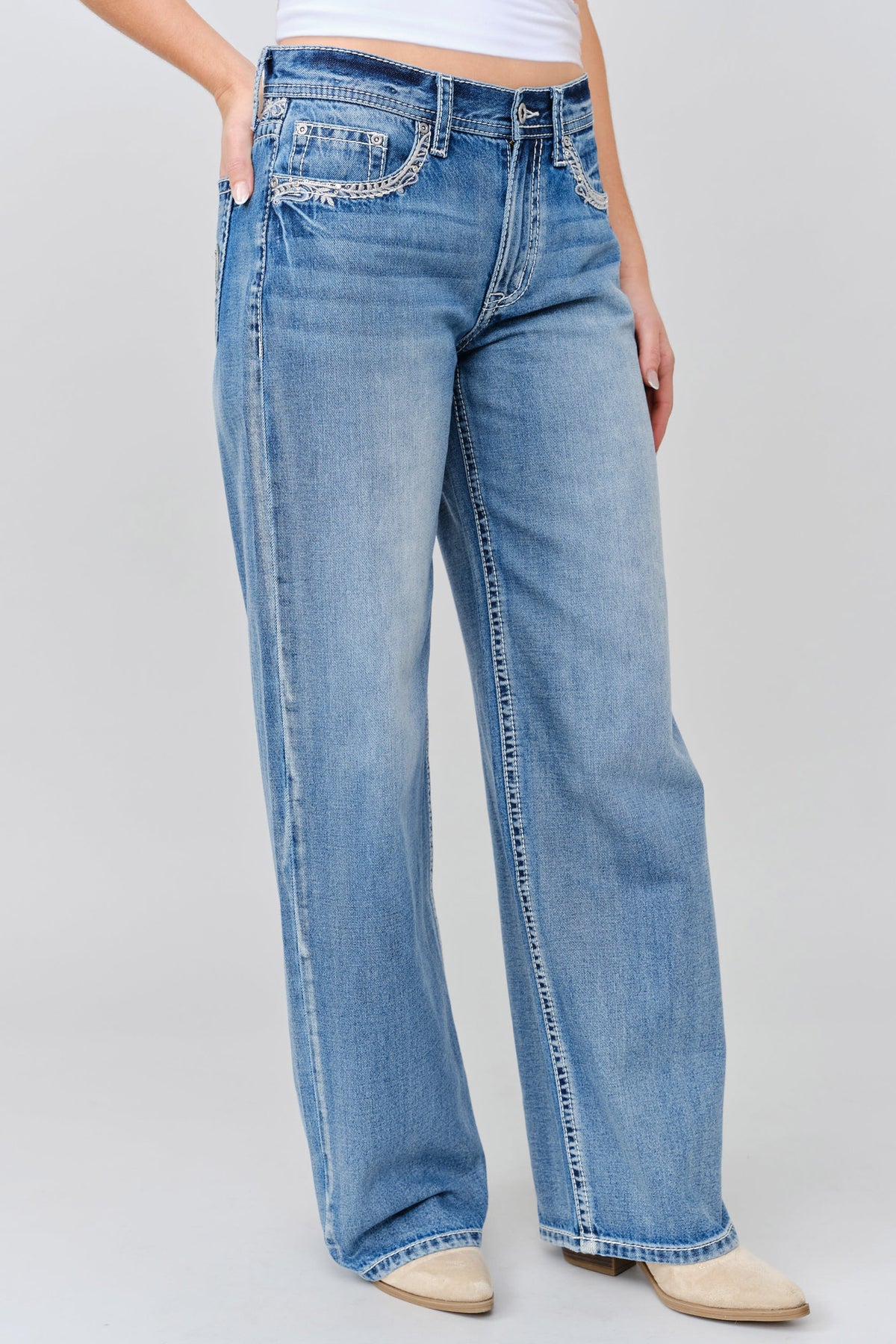 Grace in LA wide leg jeans close-up of embroidered leather applique with yoke on light wash denim